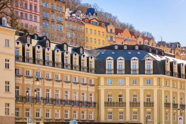 Karlovy 'deki renkli tarihi mimari çeşitlilik, güneşli bir günde Czech Cumhuriyeti. 19 Mart 2025, Karlovy Vary, Çek Cumhuriyeti.