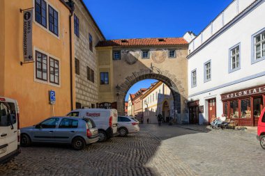 Güneşli bir günde kemer yolu ve kaldırım taşı yolu olan tarihi Avrupa sokak sahnesi. 20 Mart 2025, Cesky Krumlov, Çek.