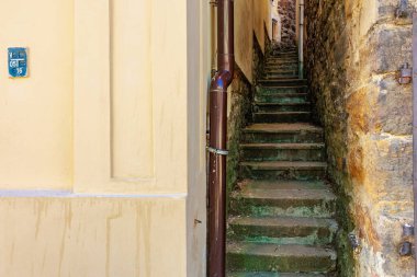 Avrupa geçidinde kırsal duvarlar arasındaki dar taş merdiven. 18 Mart 2025, Madalyon, Çek Cumhuriyeti.