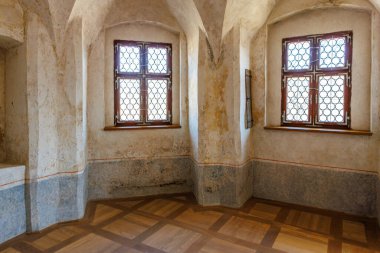 Antik taş binada kemerli tavanları ve kareli pencereleri olan tarihi bir oda. 18 Mart 2025, Madalyon, Çek Cumhuriyeti.