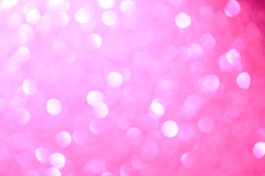 Pembe arka plan ve küçük pembe daireler. Çemberler bulanık ve örtüşüyor.