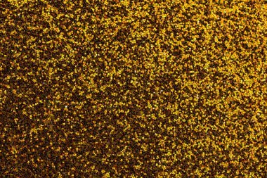 Altın ve altın renkli bir arka plan ve etrafa saçılmış altın lekeleri. Arkaplan zengin, sıcak, altın sarısı bir renktir, benekler ise daha küçük ve daha ince, biraz ışıltı katar.