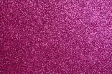 Pembe bir arka plan ve bir sürü parıltı. Parıltı tüm arka plana saçılmış.