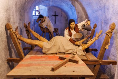 Historical torture scene with females in dungeon setting. March 18, 2025, Loket, Czech Republic.