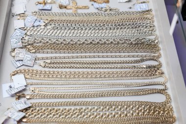 Gold and silver chains displayed on jewelry table with price tags. November 3, 2023 Balti Moldova.