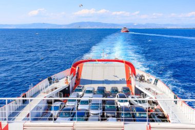 A large ship is sailing through the sea with a large number of cars on deck. August 5, 2024 Ferry from Keramoti to Thassos island Greece