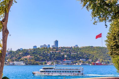 Scenic view of the bosphorus with ferry and turkish flag in istanbul. August 12, 2025 Istanbul Turkey.