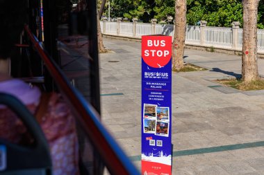 Bus stop in urban setting with tour information sign. August 12, 2025 Istanbul Turkey.
