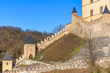 Historic medieval fortress castle with towers and walls in scenic landscape.