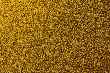 Bir sürü dokusu olan, altın ve siyah bir yüzeye yakın plan. Altın ve siyah renkler derinlik ve zenginlik hissi yaratır.