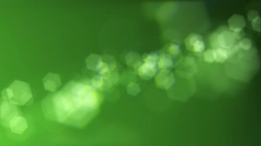 Defocused green bokeh lights background. This elegant motion animation with hexagonal bokeh particles is full HD and a seamless loop. Suitable as an abstract St Patrick's Day background.