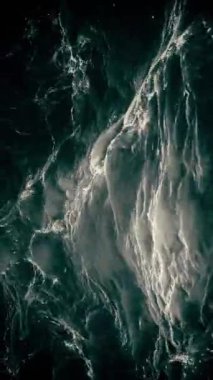 Dikey video - hızlı akan köpüklü karanlık su seli. Tam HD, döngü hareketi arkaplanı.