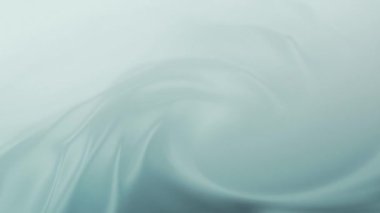 Yumuşak pastel yeşili kıvrımlı, ruhani dalgalarla soyut bir arka plan. Yumuşak akışkan hareket sakinlik ve sükunet hissi yaratır ve rahatlatıcı ve barışçıl bir ortam yayar..