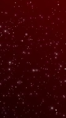 Parlak kırmızı bir Noel arkaplanı, beyaz parıldayan yıldızlar ve dönen kar parçacıkları. Tam HD ve döngülü lüks şenlikli dikey arka plan animasyonu.