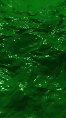 Akan yeşil sıvı arka plan dalgaları. Aziz Patrick Günü kutlamaları için nehrin yeşile boyandığı suların yeşile boyanması. Dikey Canlandırma.