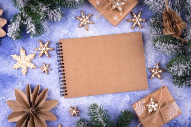 Christmas composition with empty craft notebook. New year resolution or to do list concept