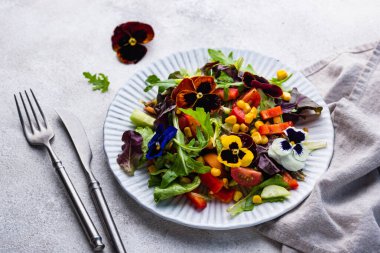 Vegetable fresh vegan salad with edible flowers