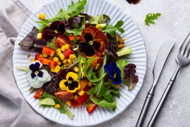 Vegetable fresh vegan salad with edible flowers