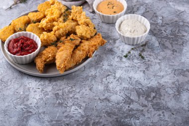 Different boneless chicken fried nuggets, strips and bites