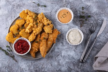 Different boneless chicken fried nuggets, strips and bites