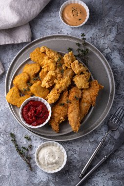 Different boneless chicken fried nuggets, strips and bites