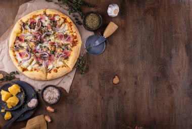 Italian home made pizza with bacon and herbs