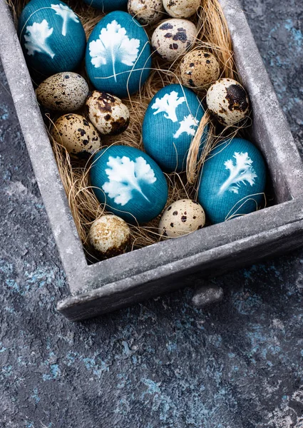 Easter eggs painted of natural dye and decorated with plant leaves