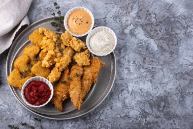 Different boneless chicken fried nuggets, strips and bites