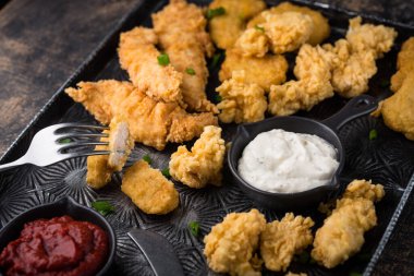 Different boneless chicken fried nuggets, strips and bites