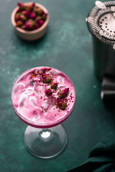 stock image Summer pink cocktail with rose flowers on dark background