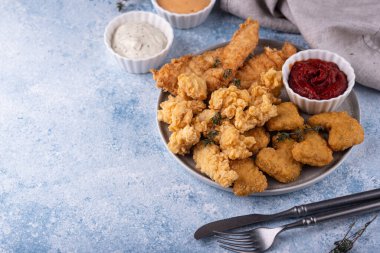 Different boneless chicken fried nuggets, strips and bites