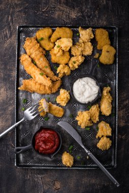 Different boneless chicken fried nuggets, strips and bites