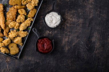 Different boneless chicken fried nuggets, strips and bites