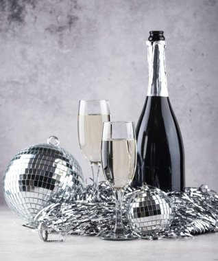 Glass of champagne with silver mirror disco ball. New year party composition