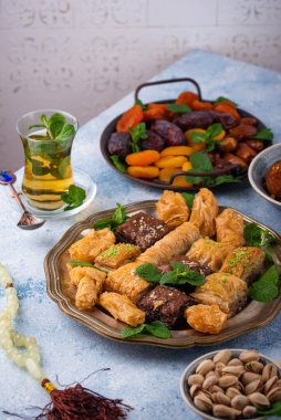 Ramadan iftar traditional desserts. Turkish and Arabic sweets baklava, pistachios, dates and dried apricots