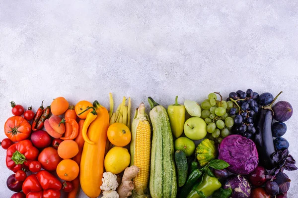 Assortment of red, yellow, green, orange, purple vegetables and fruits. Rainbow food