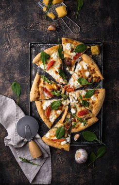 Italian home made pizza with feta cheese, tomato and basil