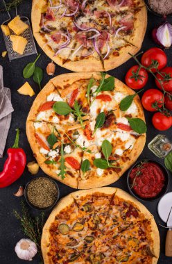 Assortment of various type of Italian pizza with bacon, chicken meat, soft cheese and tomato