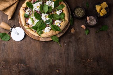 Italian pizza with soft cheese burrata or mozzarella and herbs