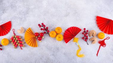 Chinese new year concept with red decoration. Money envelopes, tangerines, fans, fireworks and fortune cookies