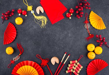 Chinese new year concept with red decoration. Money envelopes, tangerines, fans, fireworks and fortune cookies