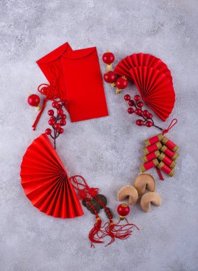 Chinese new year concept with red decoration. Money envelopes, tangerines, fans, fireworks and fortune cookies
