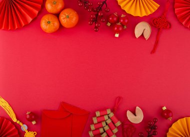 Chinese new year concept with red decoration. Money envelopes, tangerines, fans, fireworks and fortune cookies