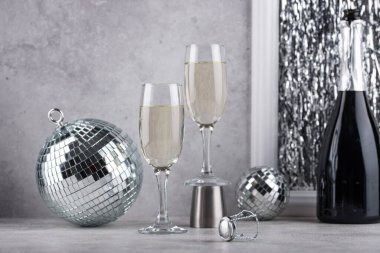 Glass of champagne with silver mirror disco ball. New year party composition