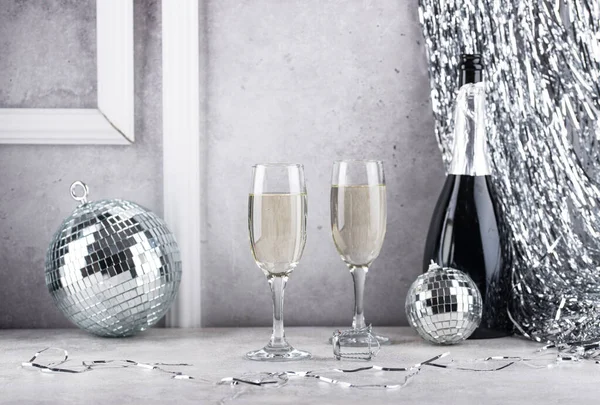 Glass of champagne with silver mirror disco ball. New year party composition