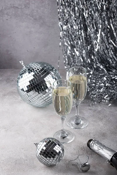 Glass of champagne with silver mirror disco ball. New year party composition