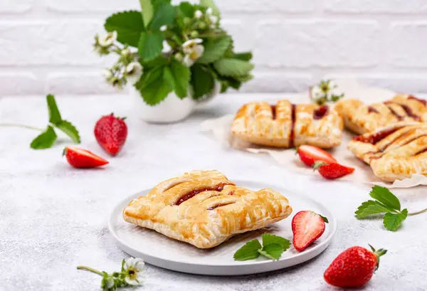 stock image Sweet puff pastry cakes with strawberry on white background
