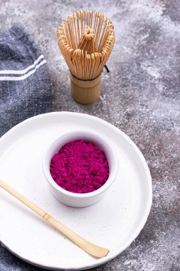 Pink matcha powder from dragon fruit with bamboo whisk clipart