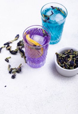 Cold blue and purple tea Butterfly pea with lemon and ice clipart