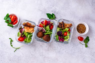 Yemek hazırlama konsepti. Konteynırda sağlıklı yiyecekler. Tavuk ve falafel soslu salata